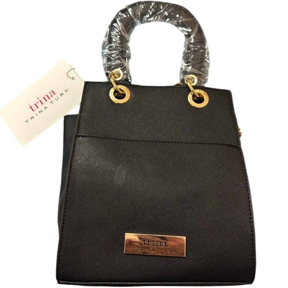 NWT Trina Turk black purse with double handles and is a Crossbody